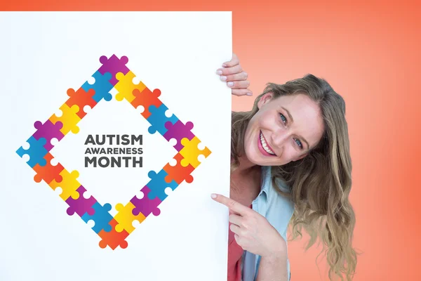 Composite image of woman holding poster — Stock Photo, Image