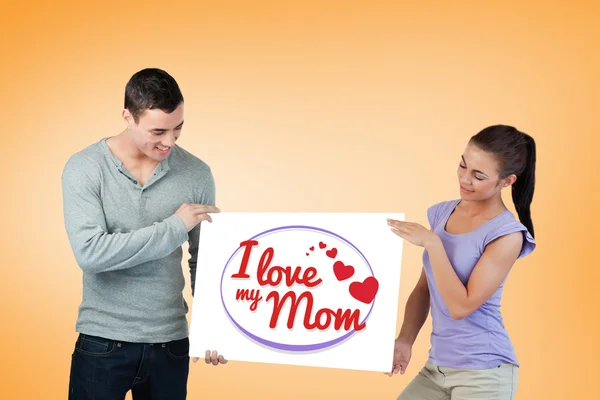 Young couple presenting banner together — Stock Photo, Image