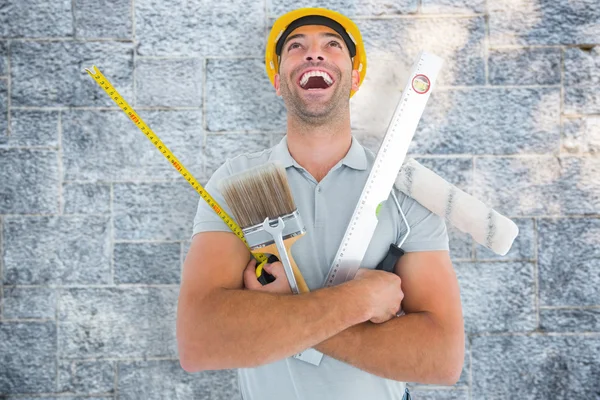 Manual worker holding various tools — Stock Photo, Image