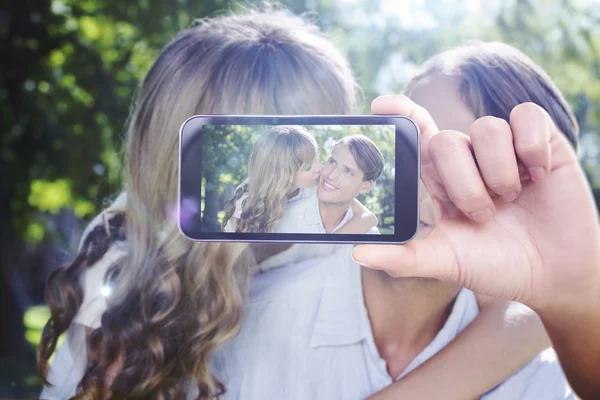 Composite image of hand holding smartphone showing — Stock Photo, Image