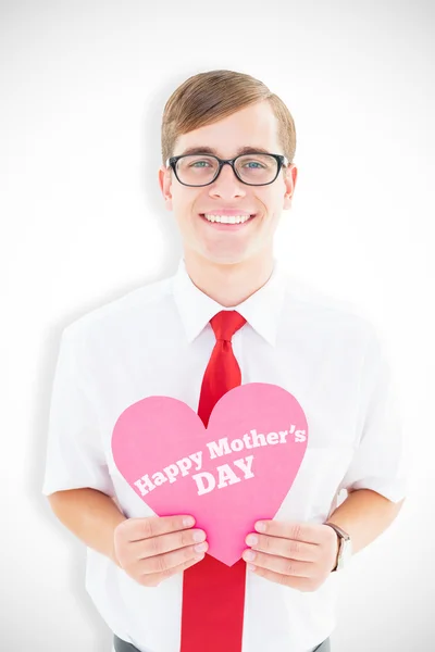 Composite image of geeky hipster holding heart card — Stock Photo, Image