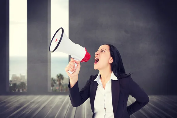 Businesswoman shouting with megaphone — Stock Photo, Image