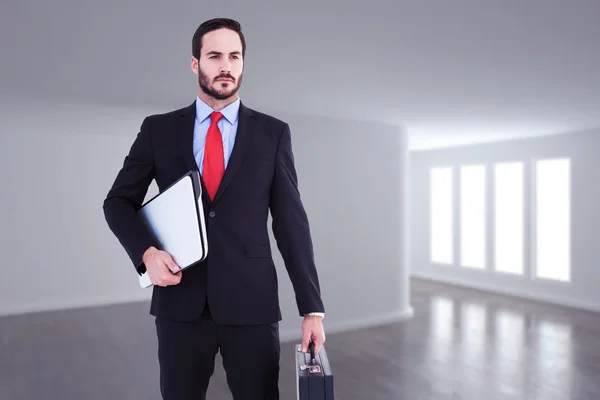 Businessman holding briefcase and laptop — Stock Photo, Image