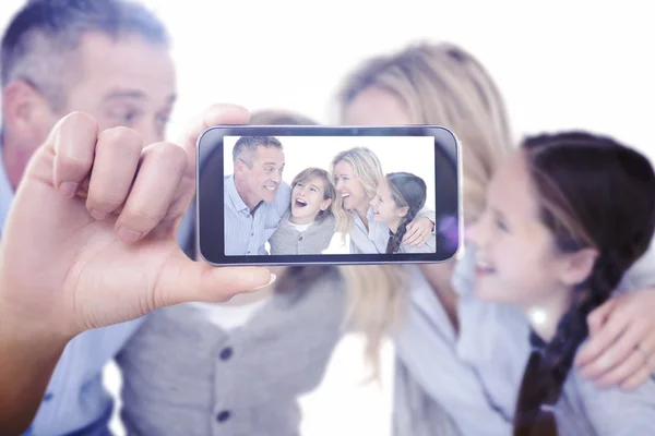 Composite image of hand holding smartphone showing — Stock Photo, Image