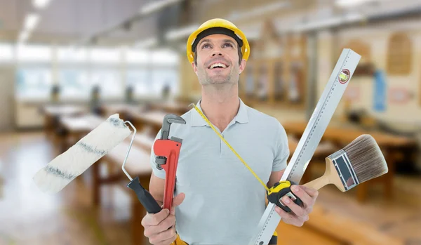 Worker holding various equipment — Stock Photo, Image