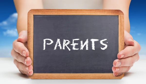 Parents and females hands showing blackboard — Stock Photo, Image