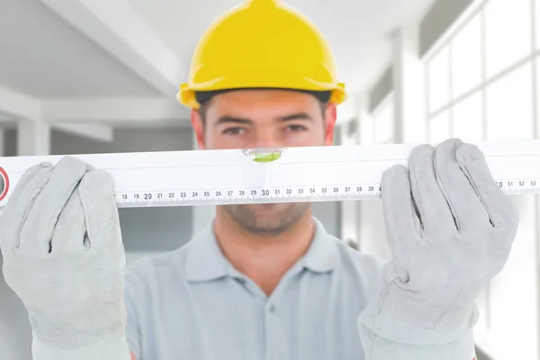 Portrait of handyman holding spirit level — Stock Photo, Image