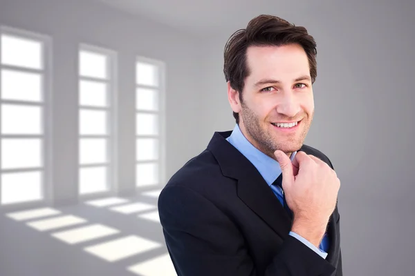 Businessman touching his chin — Stock Photo, Image