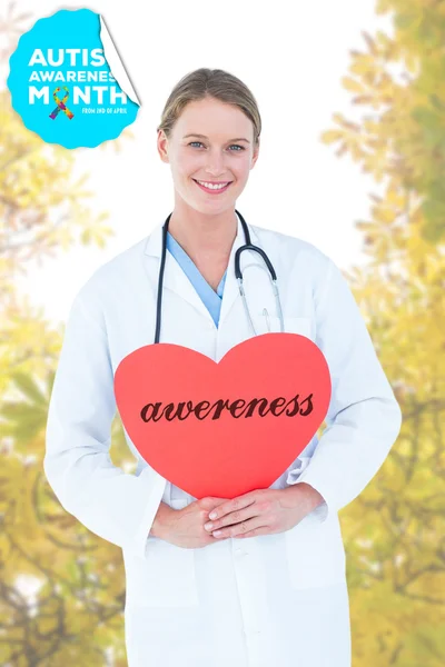 Word awereness and doctor holding card — Stock Photo, Image