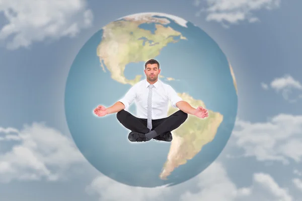 Imagem composta de empresário meditando em pose de lótus — Fotografia de Stock