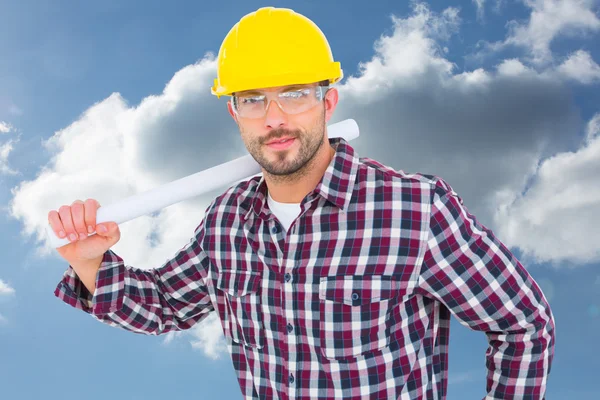 Handyman holding rolled up blueprint — Stock Photo, Image