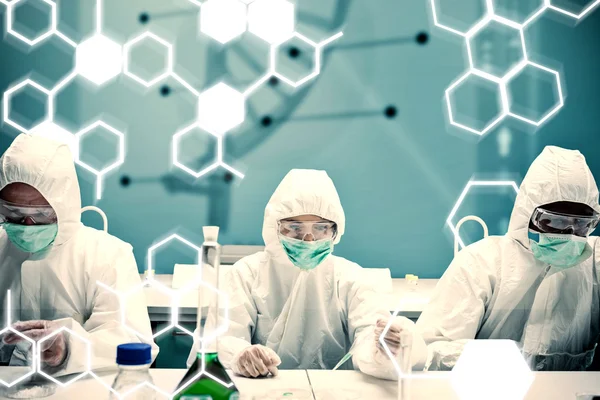 Composite image of chemists working in protective suit with futu — Stock Photo, Image