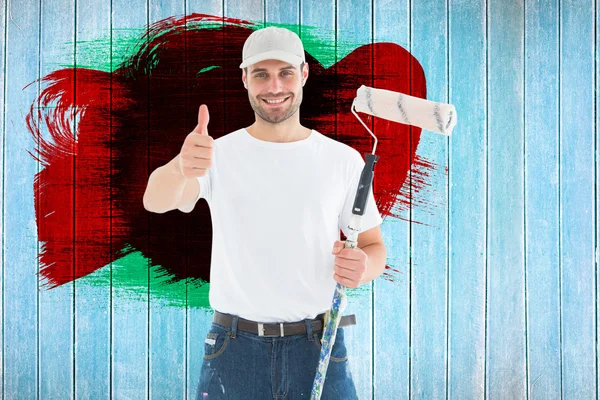 Man with paint roller gesturing thumbs up — Stock Photo, Image