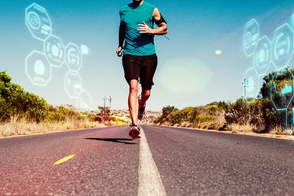 Athletic man jogging on open road — Stock Photo, Image