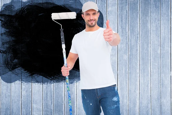 Handyman holding paint roller — Stock Photo, Image