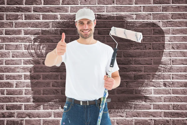 Lycklig man med paint roller gestikulerande tummen upp — Stockfoto