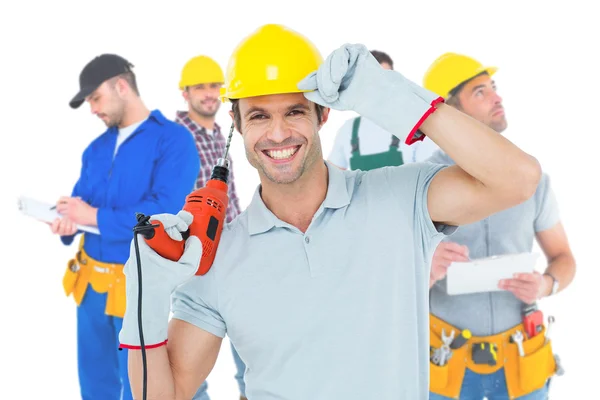 Handsome architect holding drill machine — Stock Photo, Image