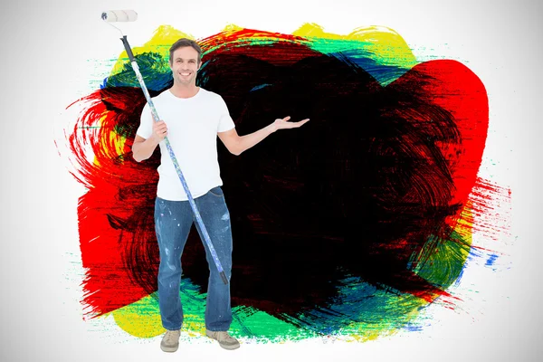 Man gesturing while holding paint roller — Stock Photo, Image