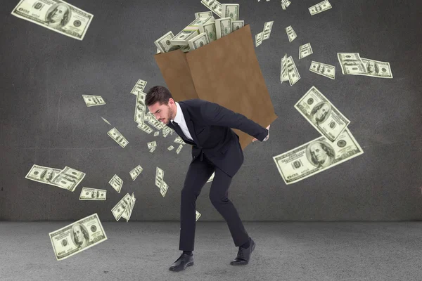 Businessman carrying bag of dollars — Stock Photo, Image