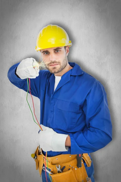 Confident repairman holding cables — Stock Photo, Image