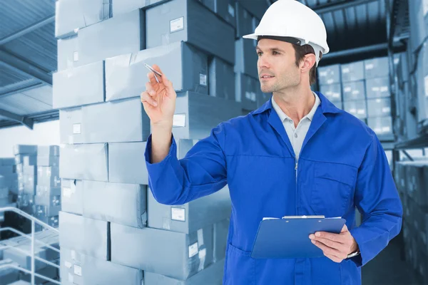 Supervisor inspecting while holding clip board — Stock Photo, Image