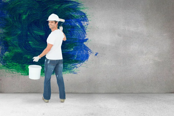 Happy man using paint roller — Stock Photo, Image