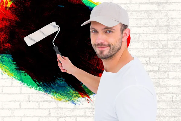 Handyman holding paint roller — Stock Photo, Image