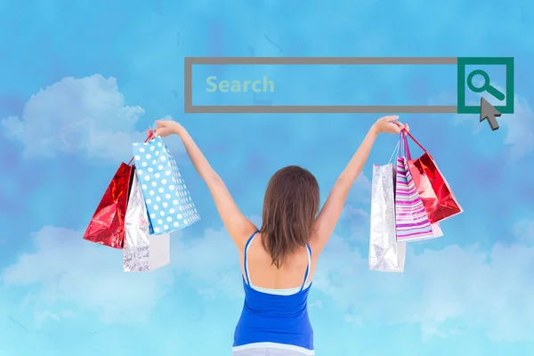 Brunette woman raising shopping bags — Stock Photo, Image