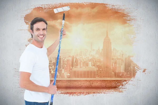 Happy man using paint roller — Stock Photo, Image