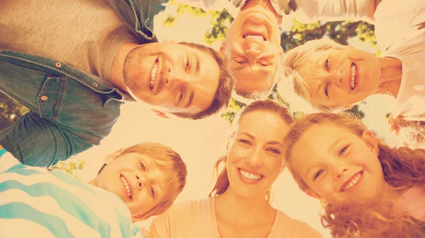 Extended family forming huddle in park — Stock Photo, Image