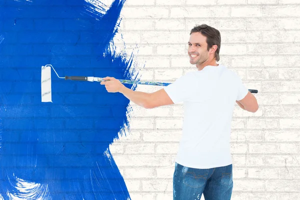 Happy man using paint roller — Stock Photo, Image