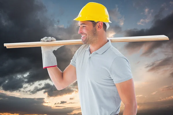 Worker with plank of wood — Stock Photo, Image