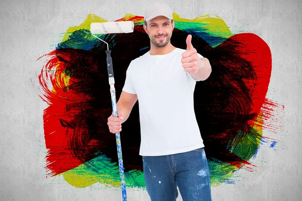 Handyman holding paint roller — Stock Photo, Image