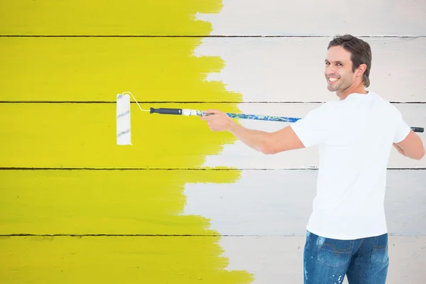 Happy man using paint roller — Stock Photo, Image