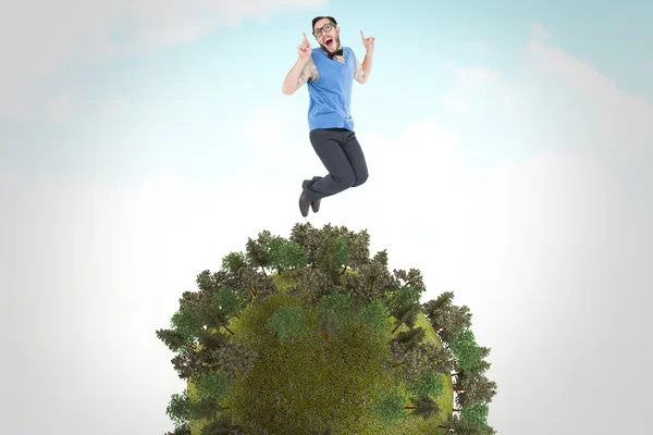 Comedy image of geeky hipster jumping and smiling — стоковое фото