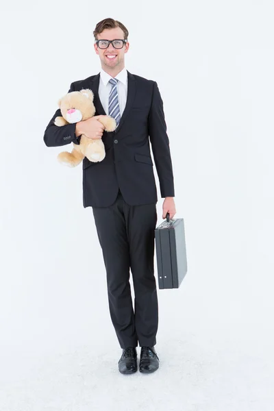 Affärsman anläggning portfölj och teddy — Stockfoto