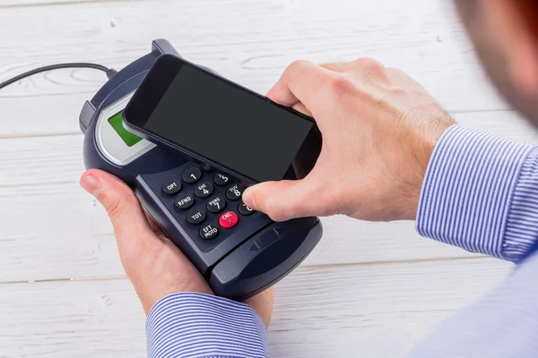 Man using smartphone to express pay — Stock Photo, Image