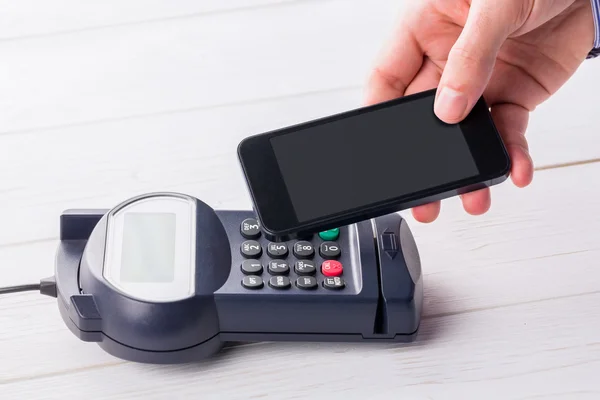 Man using smartphone to express pay — Stock Photo, Image