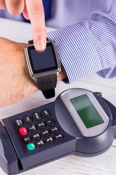 Man using smart watch to express pay — Stock Photo, Image