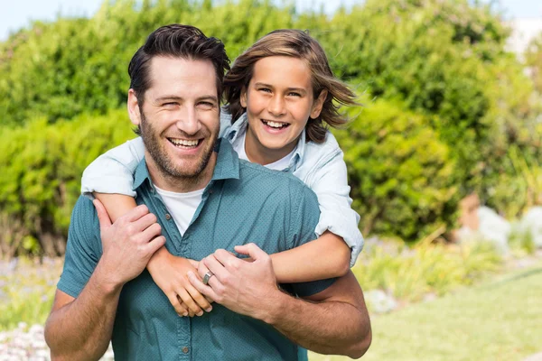 Vader en zoon glimlachen op camera — Stockfoto