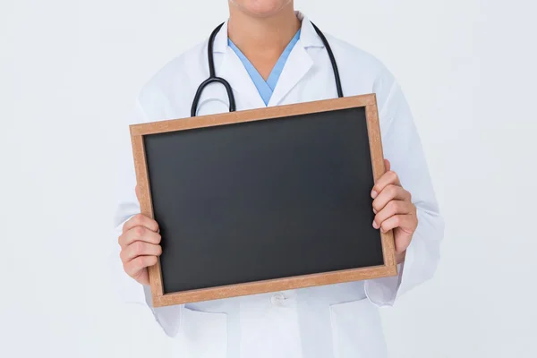 Doctor showing little blackboard — Stock Photo, Image