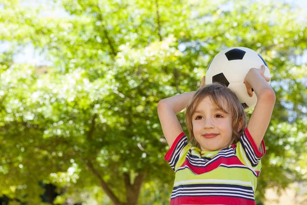 Happy little boy holding football — Stock Photo, Image