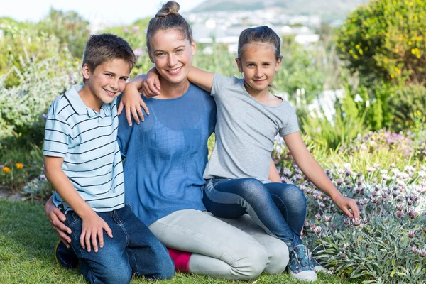 Mãe e filhos cuidando de flores — Fotografia de Stock