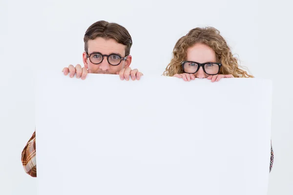 Geeky hipster couple holding poster — Stock Photo, Image