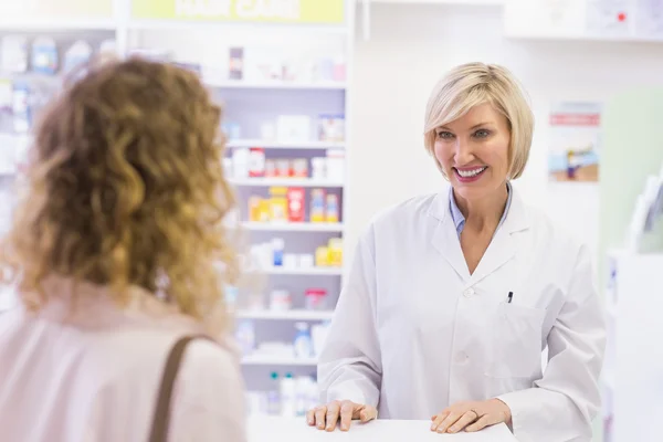 Farmacêutico sorrindo para o cliente — Fotografia de Stock