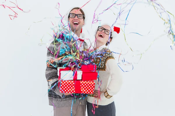 Excited geeky hipster couple looking at confetti — Stock Photo, Image