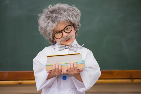 Vestido de alumno sosteniendo libros —  Fotos de Stock