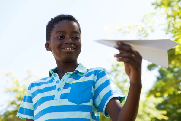 Cute little boy with paper airplane