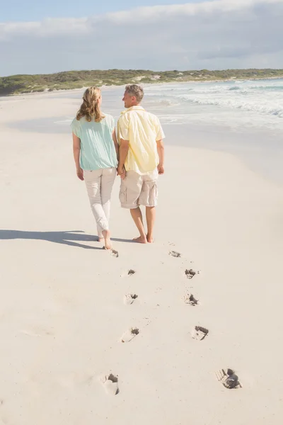 Happy couple walking holding hands — Stock Photo, Image