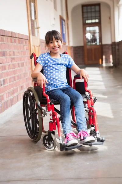 Cute disabled pupil smiling at camera in hall — Stock Photo, Image